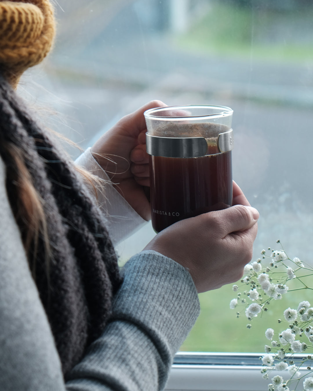 Drinking coffee out of a Barista & Co glass on a rainy day